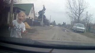 Little girl only just avoids being hit by car!