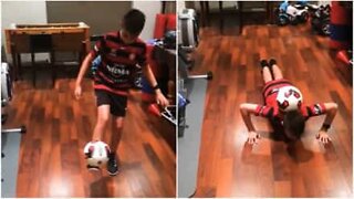 This kid does some impressive push-ups with a soccer ball