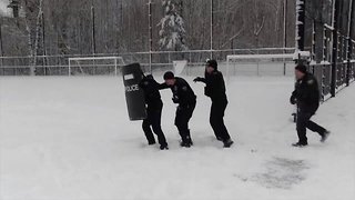 Man down: Police turn up to snowball fight with kids with their sirens blaring and holding riot shields