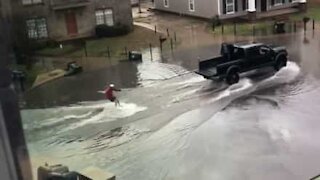 Guy goes water skiing during floods