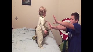 Silly Siblings Pretend to Knock over Baby