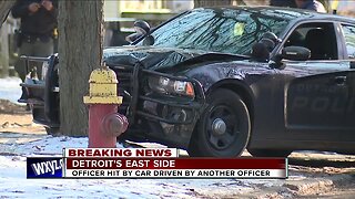DPD officer injured after being hit by cruiser while escorting suspect across the street