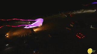 Spectacular drone view of nighttime beach kite flying