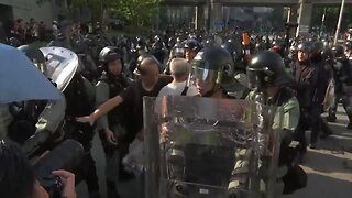 Hong Kong protesters burn flag, police fire pepper spray
