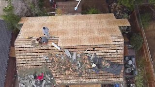 Dozens volunteer to replace old roof for woman who lived 77 years in same house