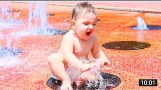 Funny baby playing with water.video