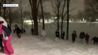 Hundreds of people participate in a snowball fight at Kent State University
