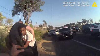 Police video shows man tackling officer before arrest