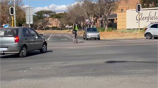 Unemployed Mahlangu brothers earn a living and a meal by controlling traffic