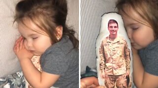 Toddler preciously cuddles pillow of her deployed military father