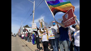 Community members protest homophobic sign