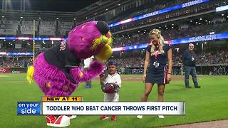 Toddler who beat cancer throws first pitch