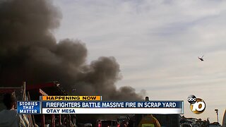 Firefighters battle massive fire in scrap yard