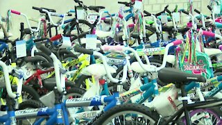 Firefighters help assemble bikes for local charity