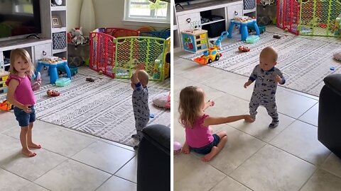 Big Sister Adorably Encourages Baby's First Steps