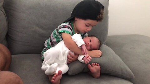 Toddler Preciously Hugs His Newborn Baby Brother
