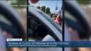 Woman accused of driving into protesters