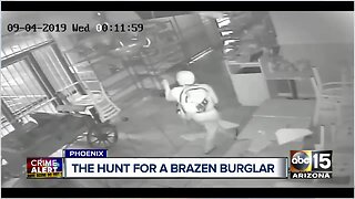 Surveillance video shows store burglar drop from ceiling