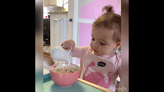Adorable baby girl eating on her table