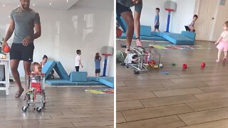Toddler pushing shopping cart literally falls for a girl