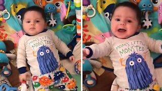 Baby adorably laughs during playtime with mommy