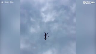 Helicopter flies with rotors still