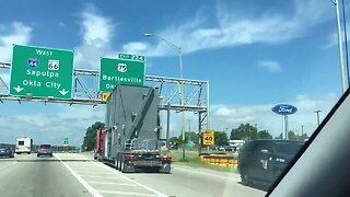 OHP trying to help cargo load pass under highway sign