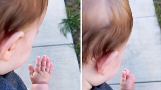 Baby girl hilariously discovers her own hand