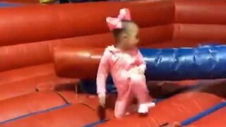 Little girl blindsided by huge inflatable arm