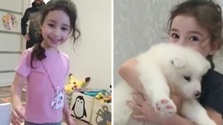 Little girl adorably happy after surprise puppy gift