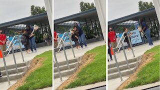 Sweet kid gives flowers to kind and patient teacher