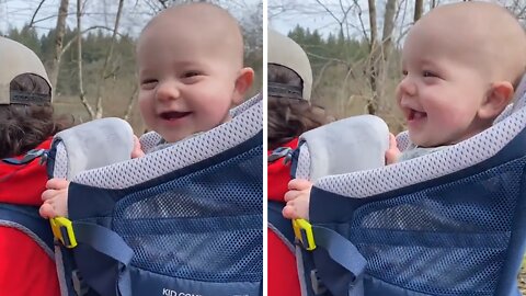 Happy baby totally enjoys his new personal backpack