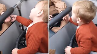 Baby boy holds hands with strangers on the bus