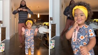 Little girl adorably dances with her dad on camera