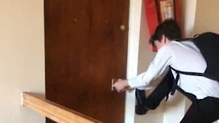 Guy fights losing battle against door