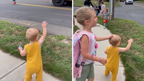 Baby boy greets big sister as she gets off the school bus