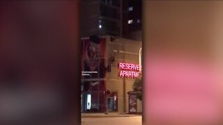 Man breaks leg after parachute gets entangled with downtown parking garage