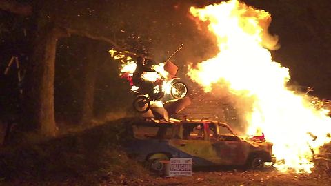 Insane bonfire dirt bike stunt captured in slow motion