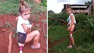 Little girl with only one leg triumphantly climbs hill