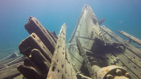 Scuba divers explore an eerie shipwreck in Devil Island Channel