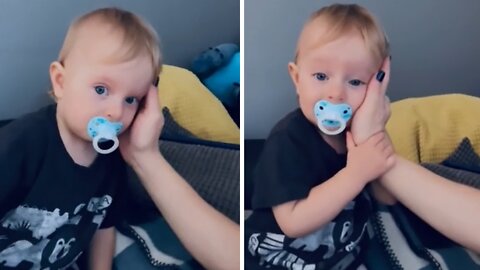 Sweet baby wants mom to hold his face all the time