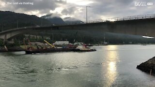 Crane hits low bridge in Alaska