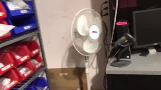 Four fans in a warehouse.