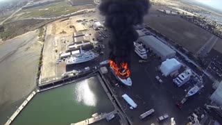 Yacht On Fire In Shipyard - Aerial View From Drone