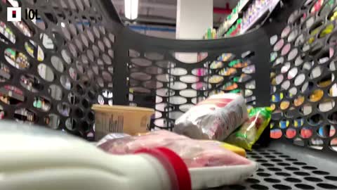 Trolley with groceries being placed inside