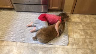 Little Girl Gently Loves Her Big Bunny