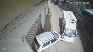 Runaway Truck Pushes Parked Car Into Building