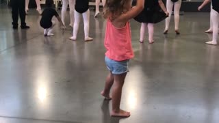 Little girl tries to keep up with ballerina class