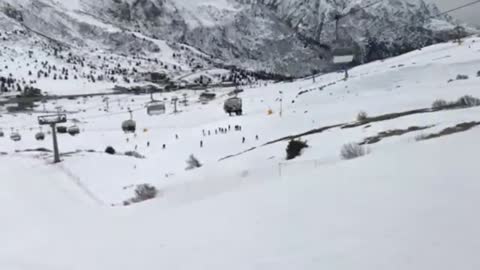 Snowboarder jumps off ramp and lands on knees