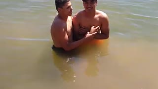 Ralph baptizing Olioni